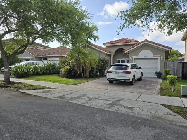 13016 Southwest 142nd Terrace Miami, FL 33186 - Photo 2 of 67 a car parked in front of a house