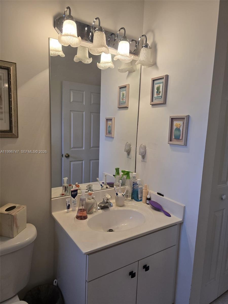 13016 Southwest 142nd Terrace Miami, FL 33186 - Photo 23 of 67 a bathroom with a sink and a mirror