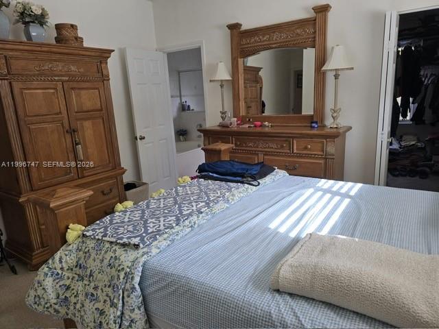13016 Southwest 142nd Terrace Miami, FL 33186 - Photo 28 of 67 a living room with a bed and dresser
