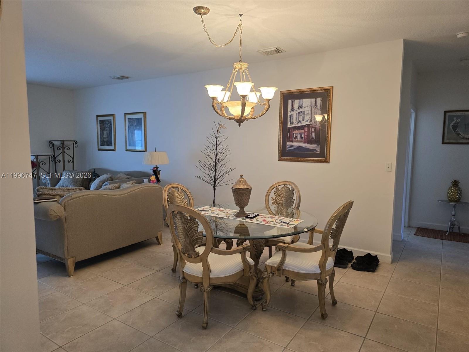 13016 Southwest 142nd Terrace Miami, FL 33186 - Photo 34 of 67 a view of a dining room with furniture and chandelier