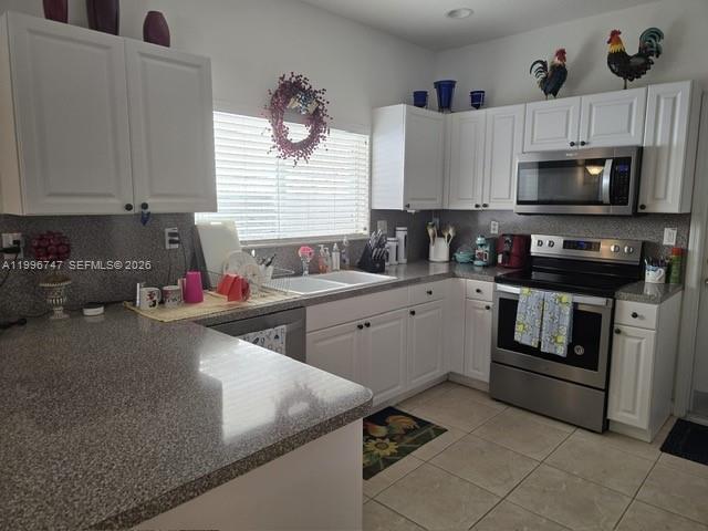13016 Southwest 142nd Terrace Miami, FL 33186 - Photo 40 of 67 a kitchen that has a sink and a stove