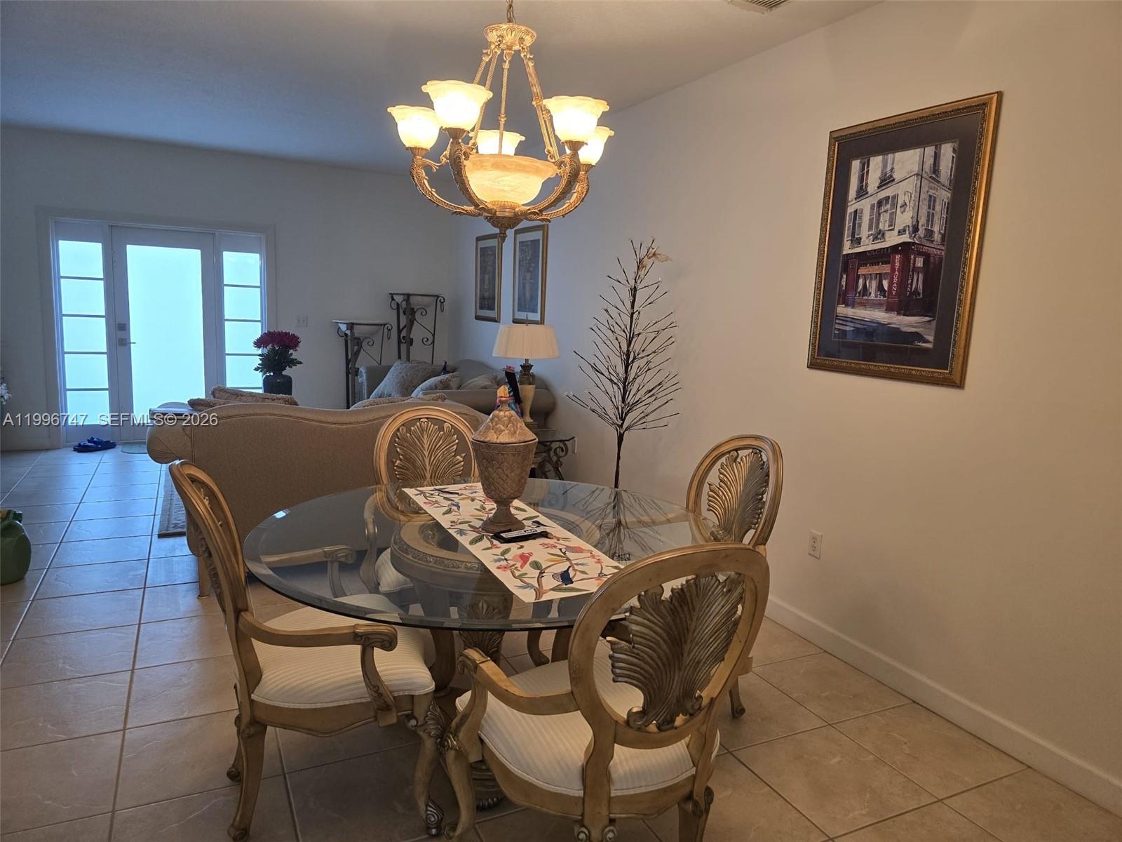13016 Southwest 142nd Terrace Miami, FL 33186 - Photo 41 of 67 a view of a dining room with furniture a chandelier and window