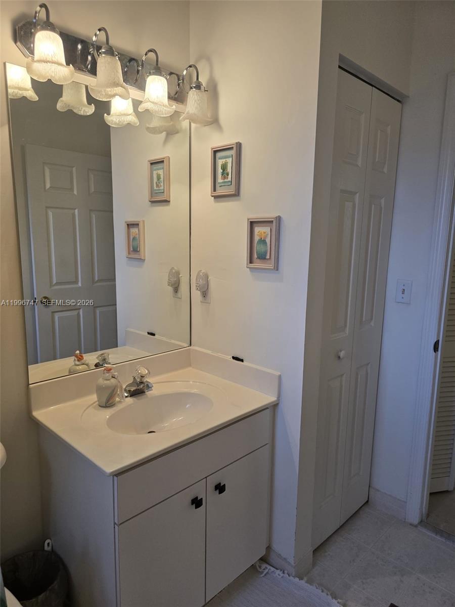 13016 Southwest 142nd Terrace Miami, FL 33186 - Photo 45 of 67 a bathroom with a sink and a mirror