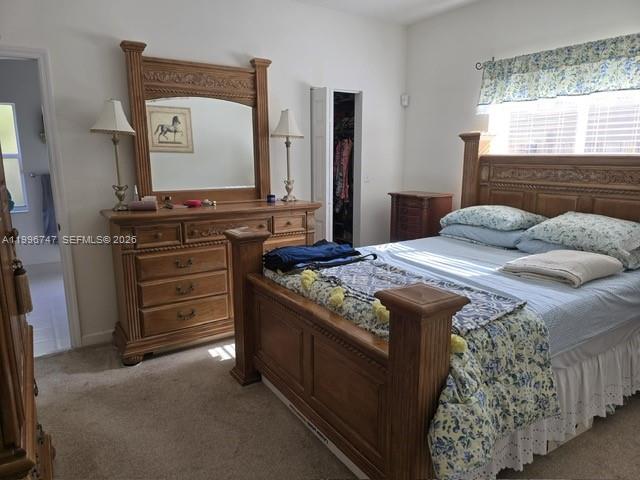 13016 Southwest 142nd Terrace Miami, FL 33186 - Photo 46 of 67 a bedroom with a bed and a mirror on dresser