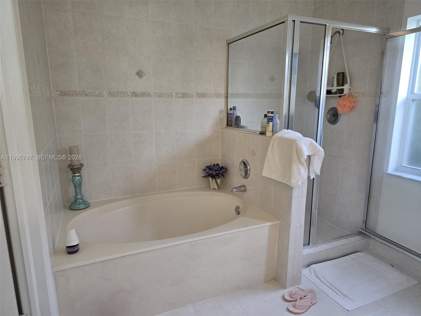 13016 Southwest 142nd Terrace Miami, FL 33186 - Photo 49 of 67 a white bath tub sitting next to a white sink and vanity
