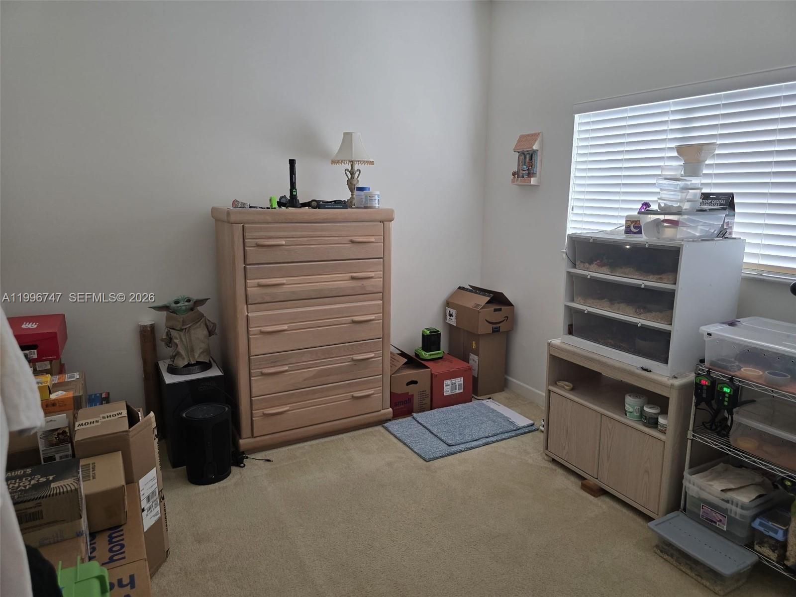 13016 Southwest 142nd Terrace Miami, FL 33186 - Photo 50 of 67 a view of walk in closet with clothes and shoes