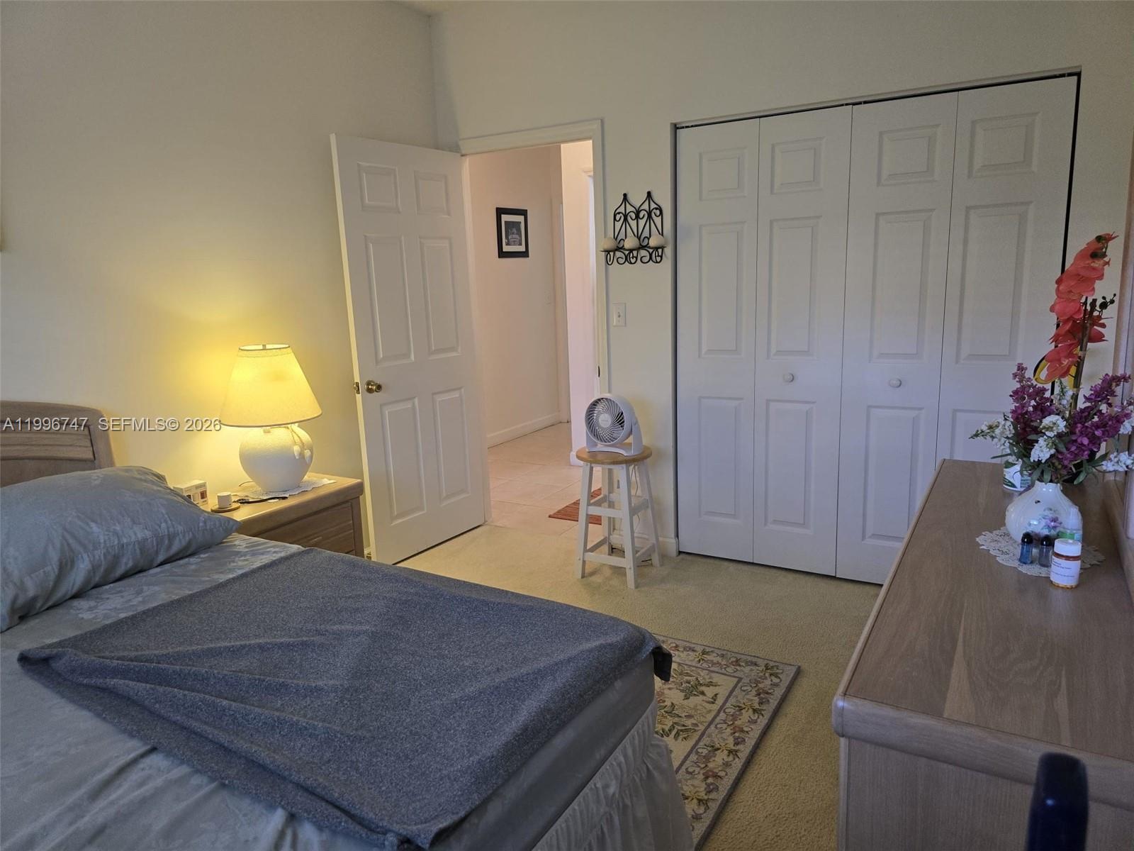 13016 Southwest 142nd Terrace Miami, FL 33186 - Photo 51 of 67 a bedroom with a bed a table and potted plant