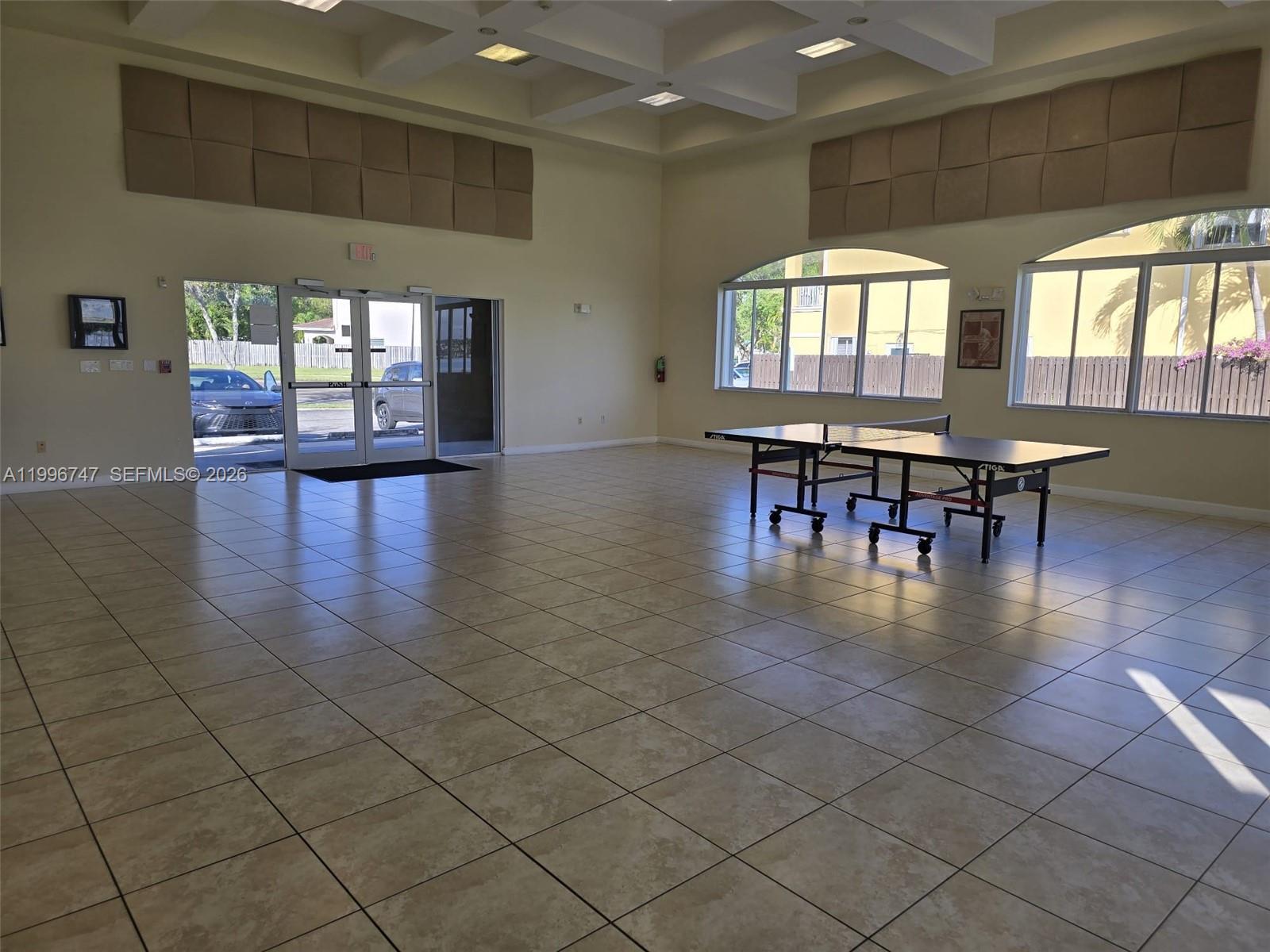 13016 Southwest 142nd Terrace Miami, FL 33186 - Photo 58 of 67 an dining room with lots of wooden furniture and a floor to ceiling window