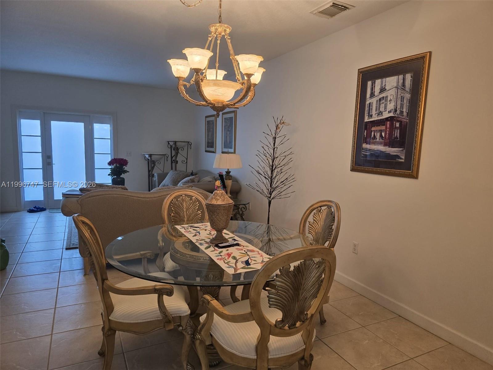 13016 Southwest 142nd Terrace Miami, FL 33186 - Photo 7 of 67 a view of a dining room with furniture and chandelier