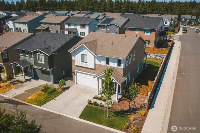 an aerial view of a house with yard swimming pool and outdoor seating