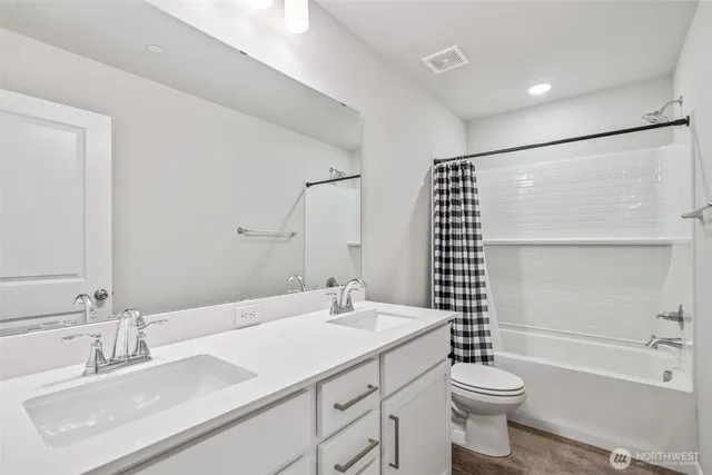 a spacious bedroom with a bed and glass windows