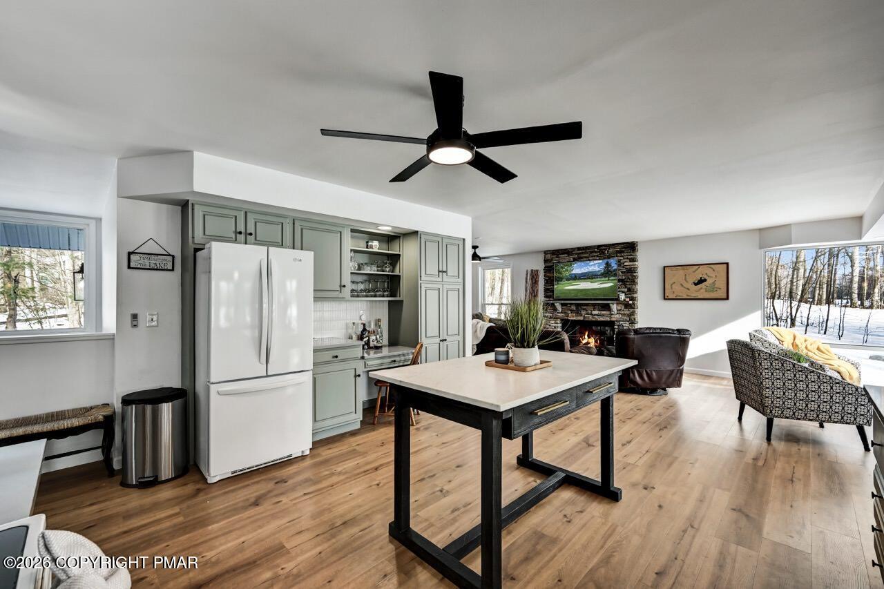 116 Spyglass Hill Road Tobyhanna, PA 18466 - Photo 16 of 73 a kitchen with stainless steel appliances granite countertop a refrigerator a stove a dining table and chairs with wooden floor