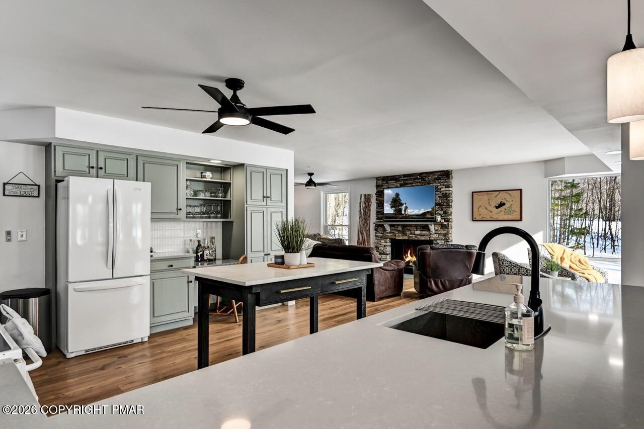 116 Spyglass Hill Road Tobyhanna, PA 18466 - Photo 17 of 73 a kitchen with stainless steel appliances granite countertop a refrigerator a stove a sink a dining table and chairs with wooden floor