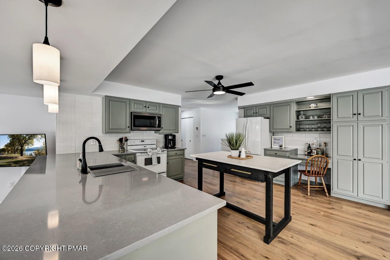 116 Spyglass Hill Road Tobyhanna, PA 18466 - Photo 18 of 73 a kitchen with stainless steel appliances granite countertop a sink a microwave and wooden floor