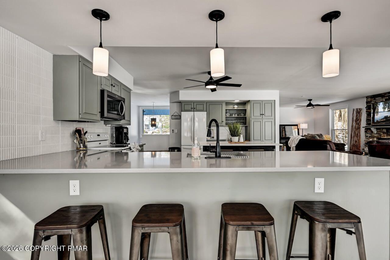 116 Spyglass Hill Road Tobyhanna, PA 18466 - Photo 19 of 73 a kitchen with stainless steel appliances granite countertop a dining table chairs a sink and dishwasher a refrigerator with wooden floor