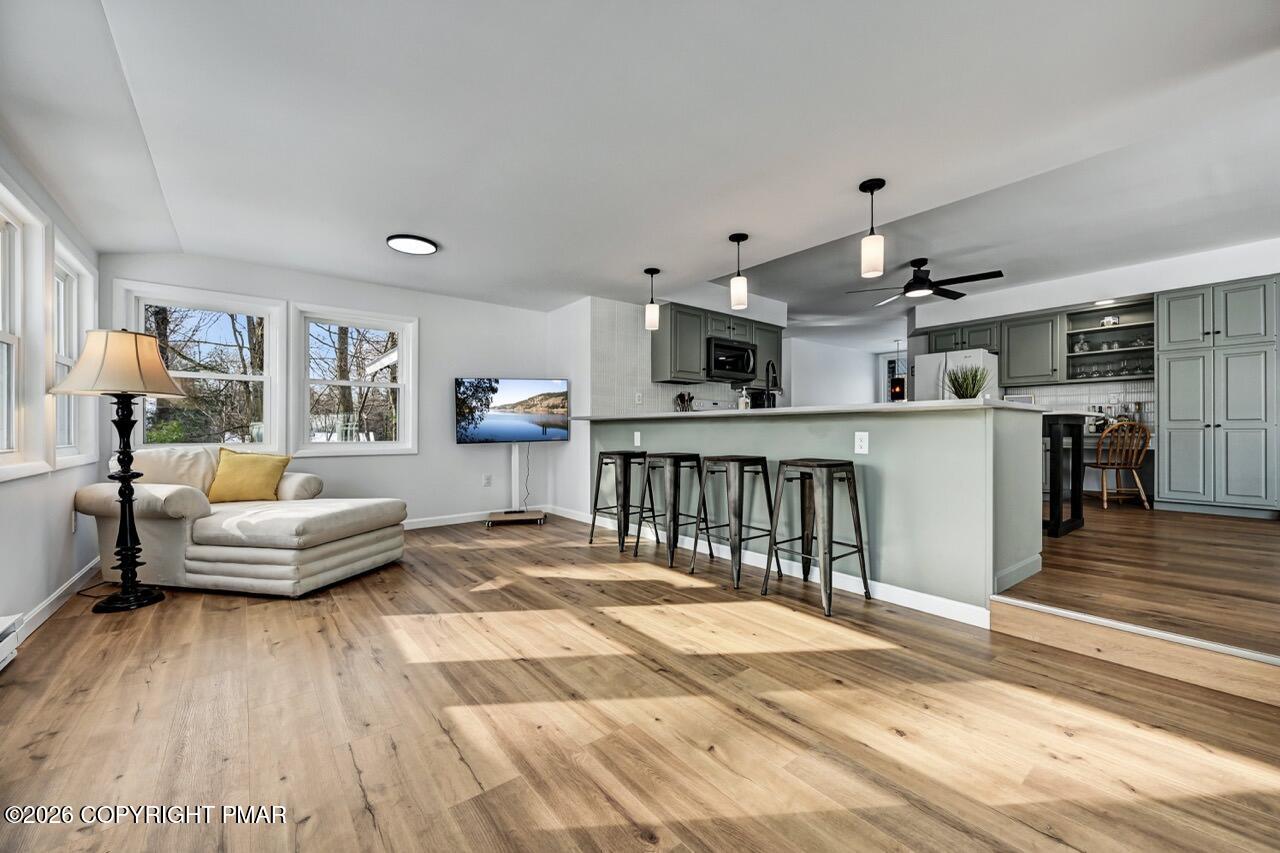 116 Spyglass Hill Road Tobyhanna, PA 18466 - Photo 22 of 73 a living room with kitchen island furniture and a wooden floor