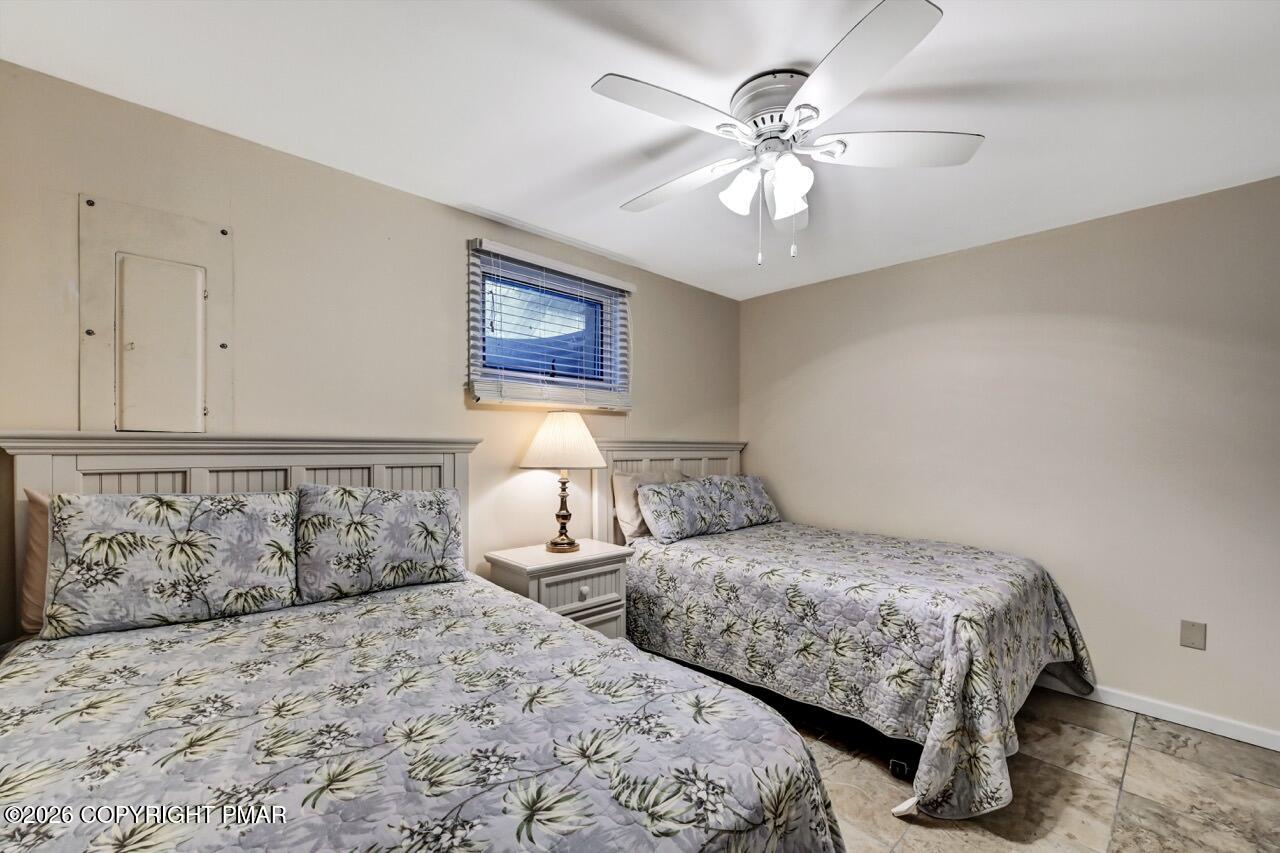 116 Spyglass Hill Road Tobyhanna, PA 18466 - Photo 51 of 73 a bedroom with two beds and a chandelier