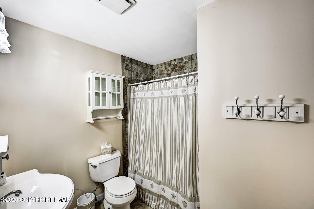 116 Spyglass Hill Road Tobyhanna, PA 18466 - Photo 52 of 73 a white toilet sitting next to a bathroom sink