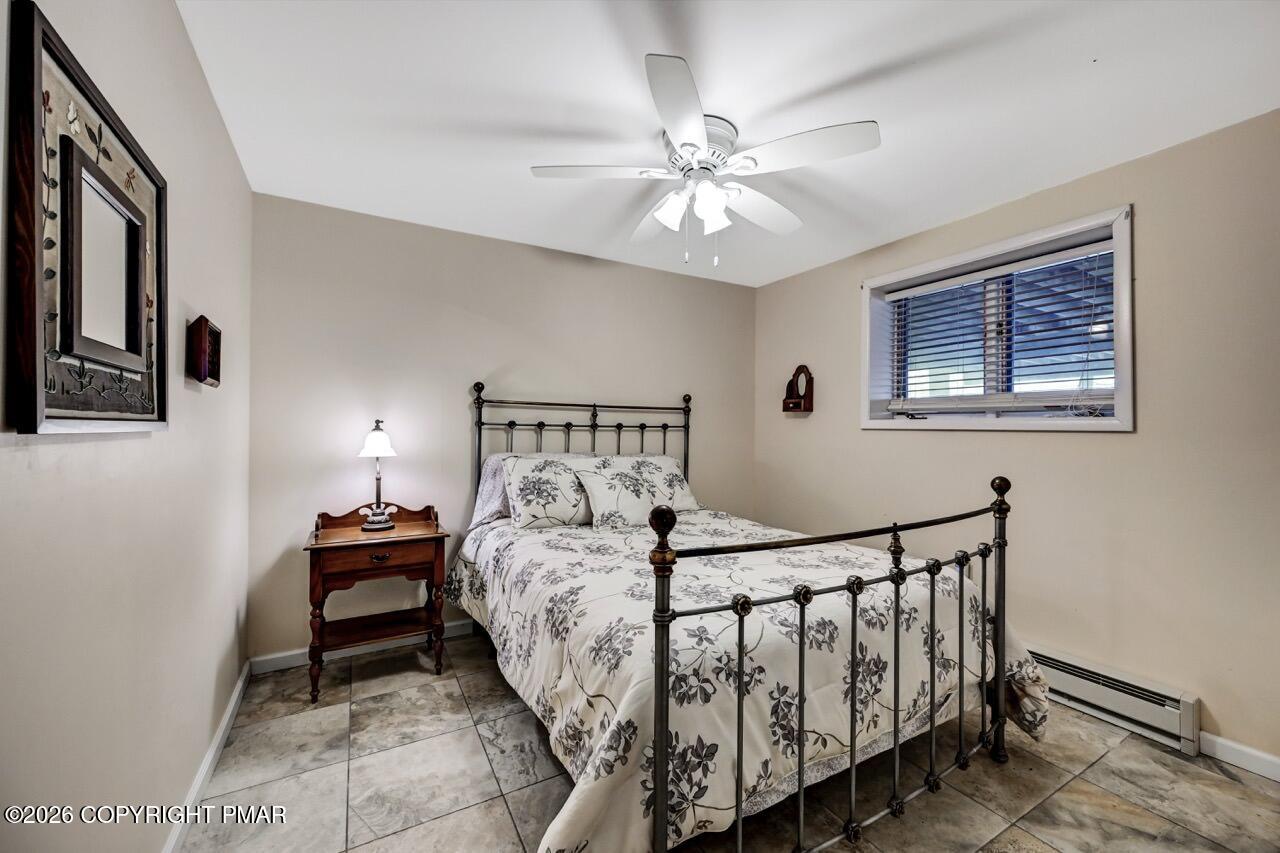 116 Spyglass Hill Road Tobyhanna, PA 18466 - Photo 55 of 73 a bedroom with a bed and a chandelier