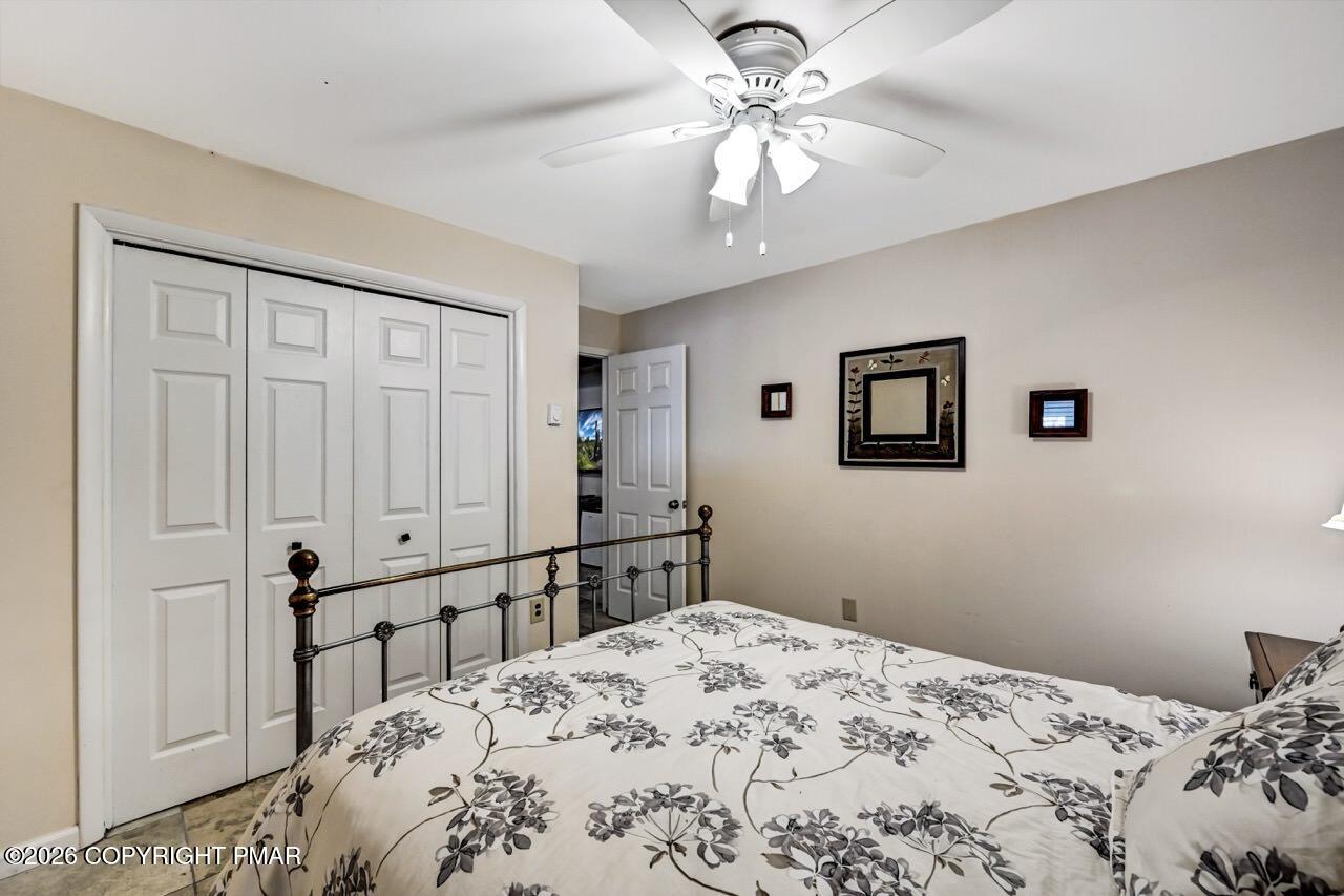 116 Spyglass Hill Road Tobyhanna, PA 18466 - Photo 56 of 73 a bedroom with a large bed and a chandelier