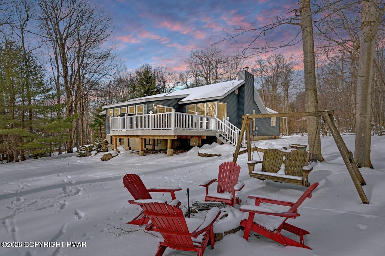 116 Spyglass Hill Road Tobyhanna, PA 18466 - Photo 5 of 73 a view of a patio with table and chairs with wooden fence and plants