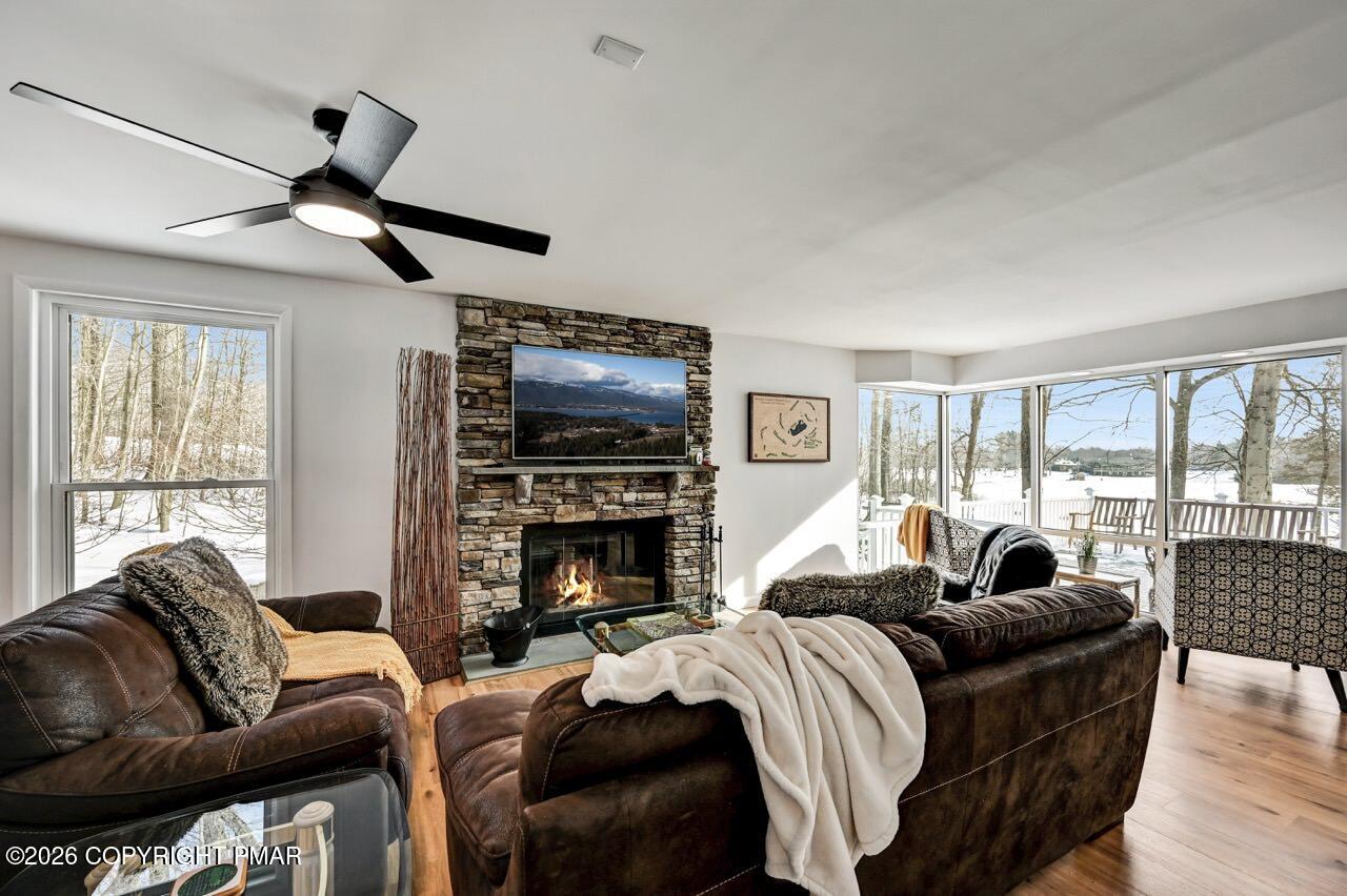 116 Spyglass Hill Road Tobyhanna, PA 18466 - Photo 8 of 73 a living room with furniture a flat screen tv and a fireplace