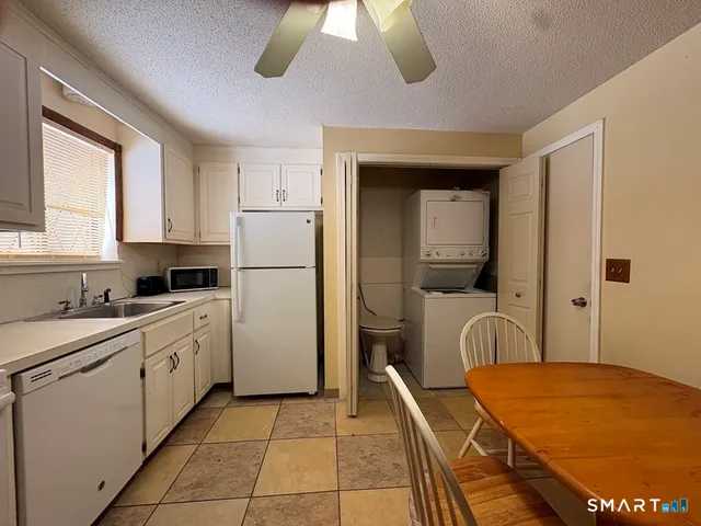 a kitchen with a refrigerator and cabinets