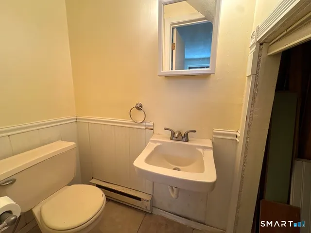 a bathroom with a sink toilet and mirror