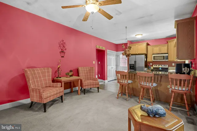 a living room with furniture a rug and a chandelier