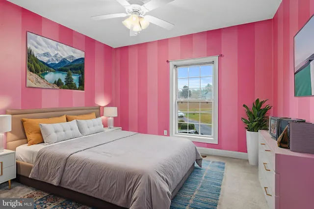 a bedroom with a bed and a potted plant