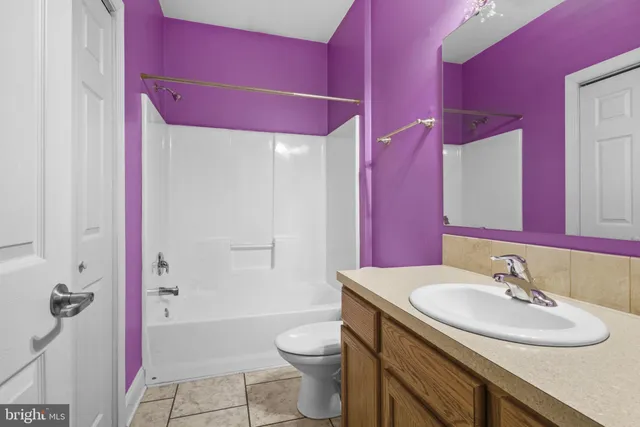 a bathroom with a sink a toilet a mirror and vanity