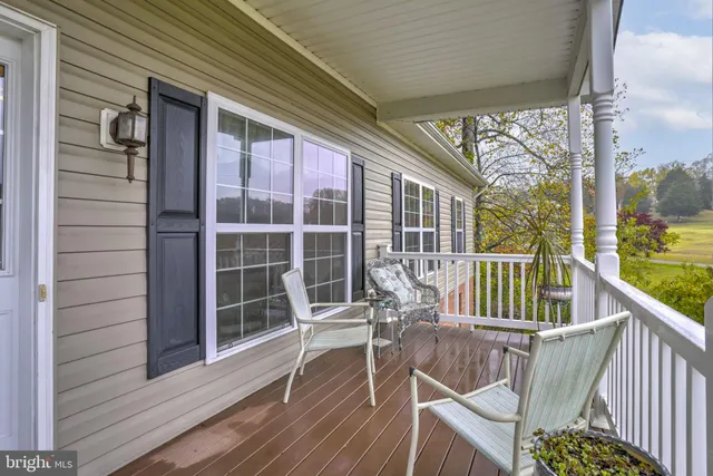 a view of balcony with wooden floor and outdoor seating