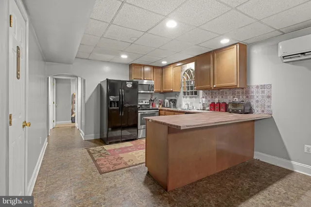 a kitchen with refrigerator and cabinets