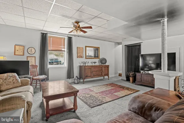 a living room with lots of furniture and a rug
