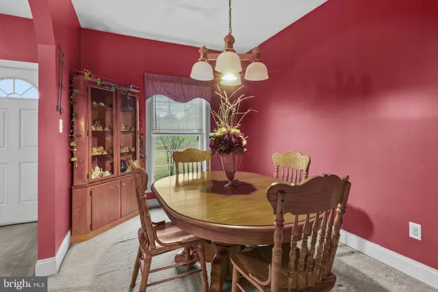 a dining room with furniture and chandelier