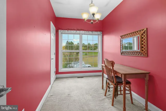 a dining room with furniture and a chandelier