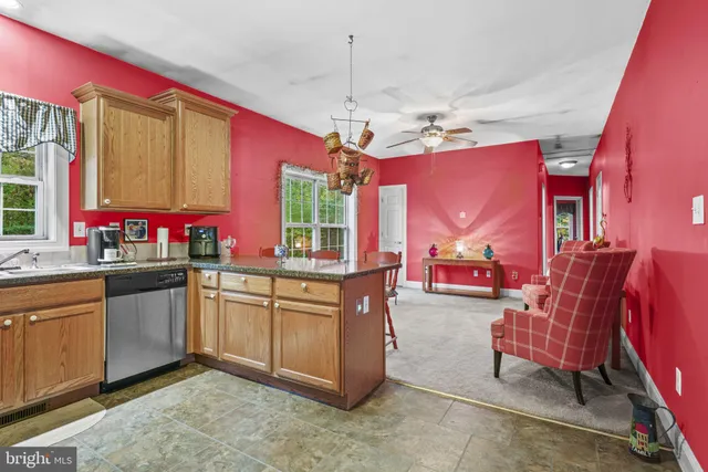 a kitchen with stainless steel appliances granite countertop a stove and cabinets