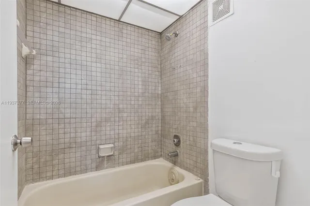 a bathroom with a bathtub and a toilet