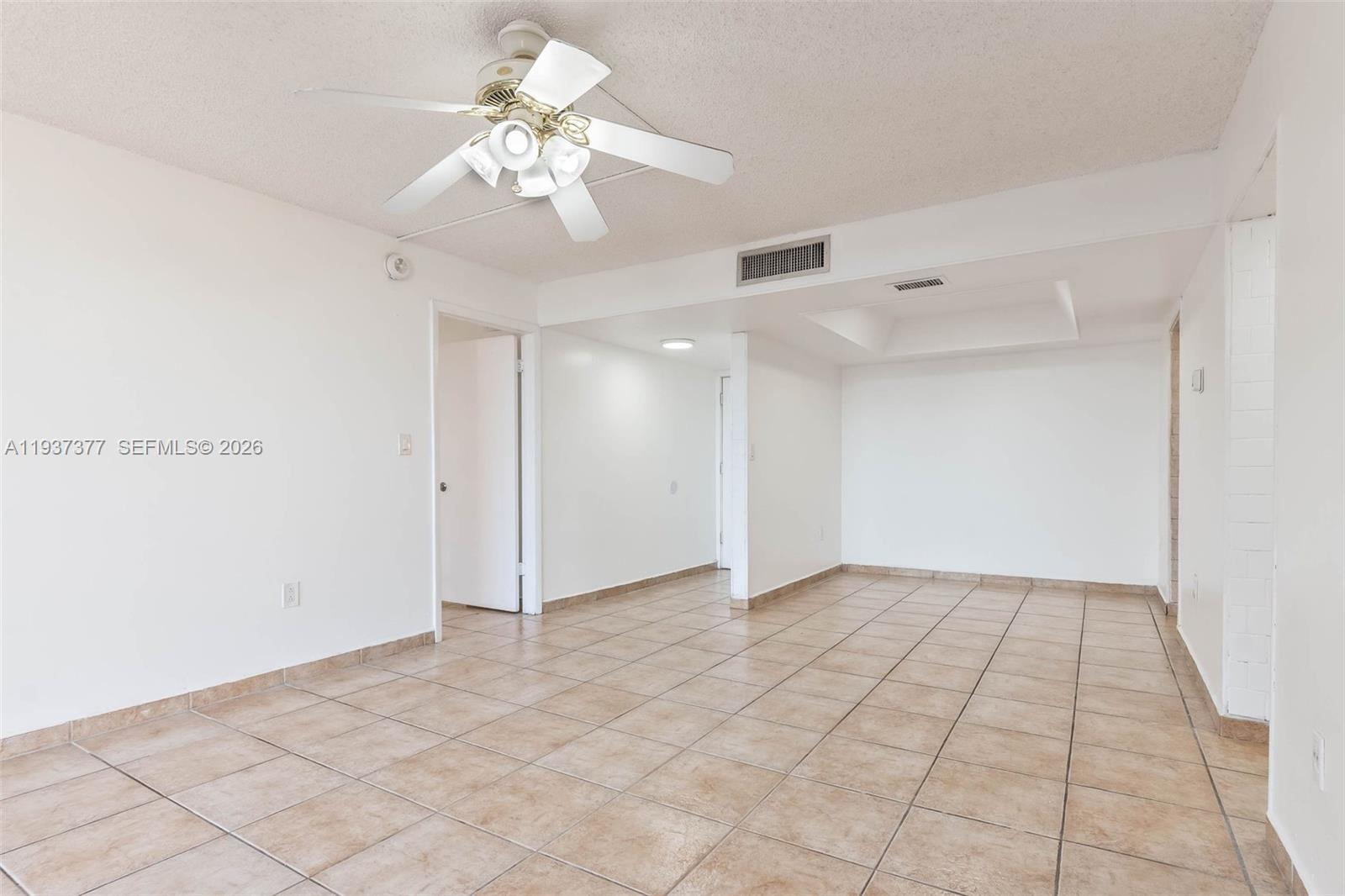10985 Southwest 107th Street, Unit 310 Miami, FL 33176 - Photo 2 of 30 a view of an empty room and chandelier fan