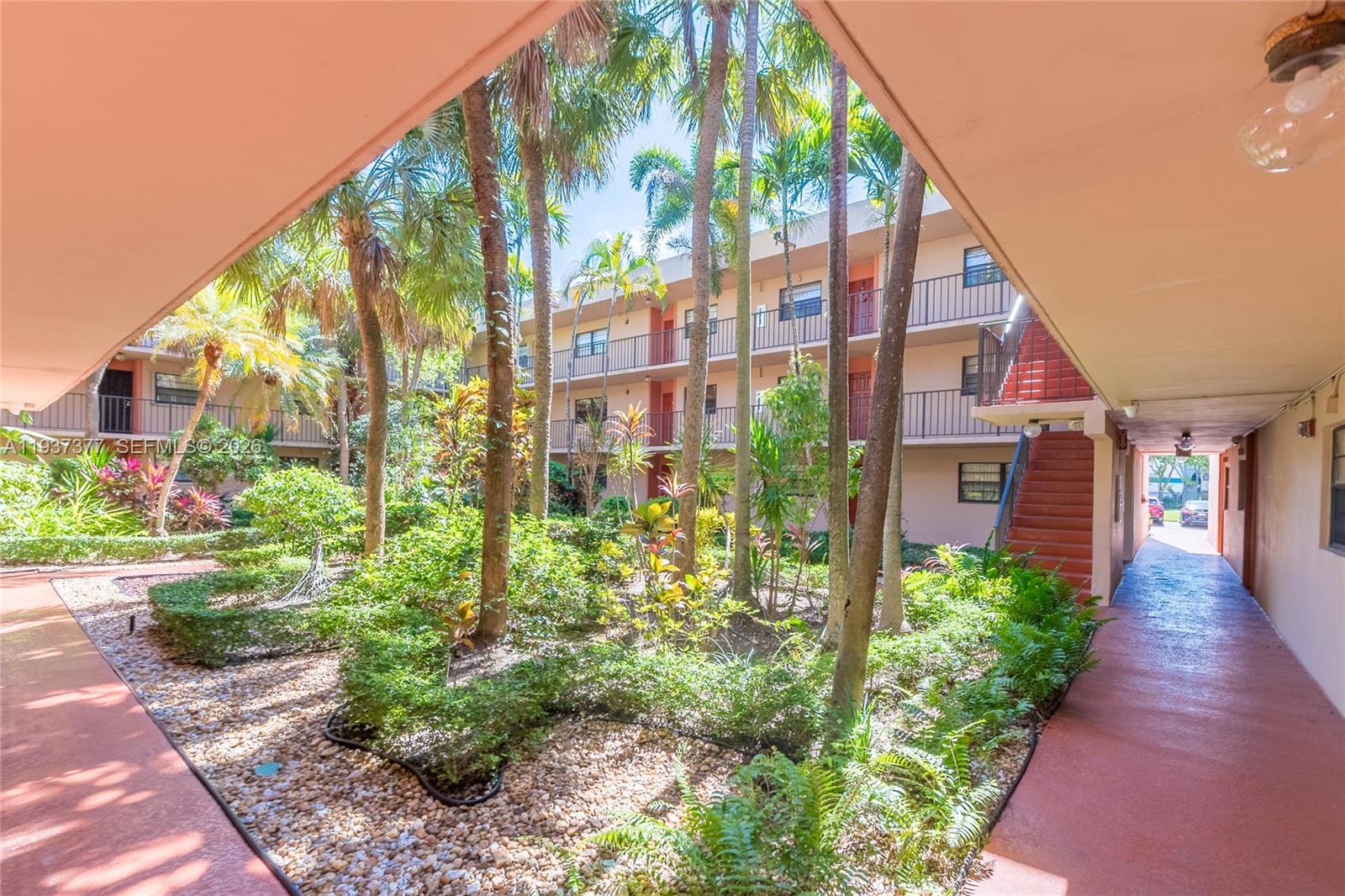 10985 Southwest 107th Street, Unit 310 Miami, FL 33176 - Photo 24 of 30 a view of a pathway along the garden