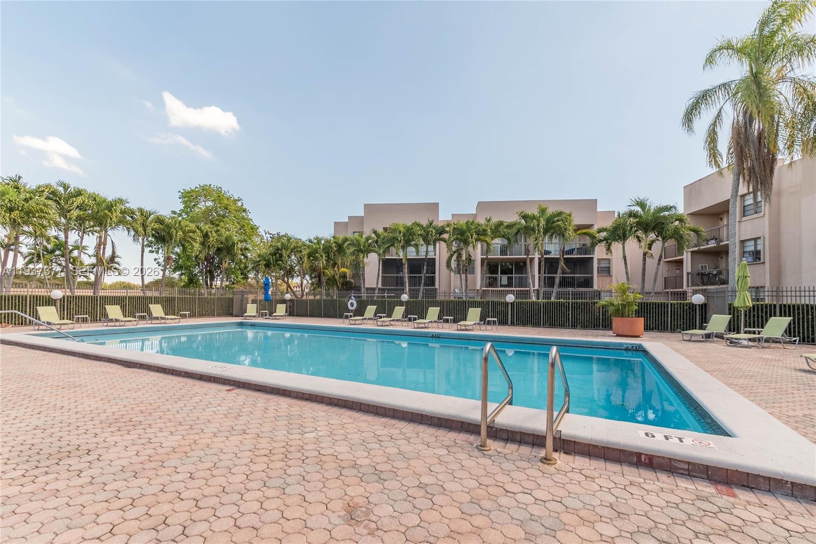 10985 Southwest 107th Street, Unit 310 Miami, FL 33176 - Photo 25 of 30 a view of a swimming pool with a lounge chairs