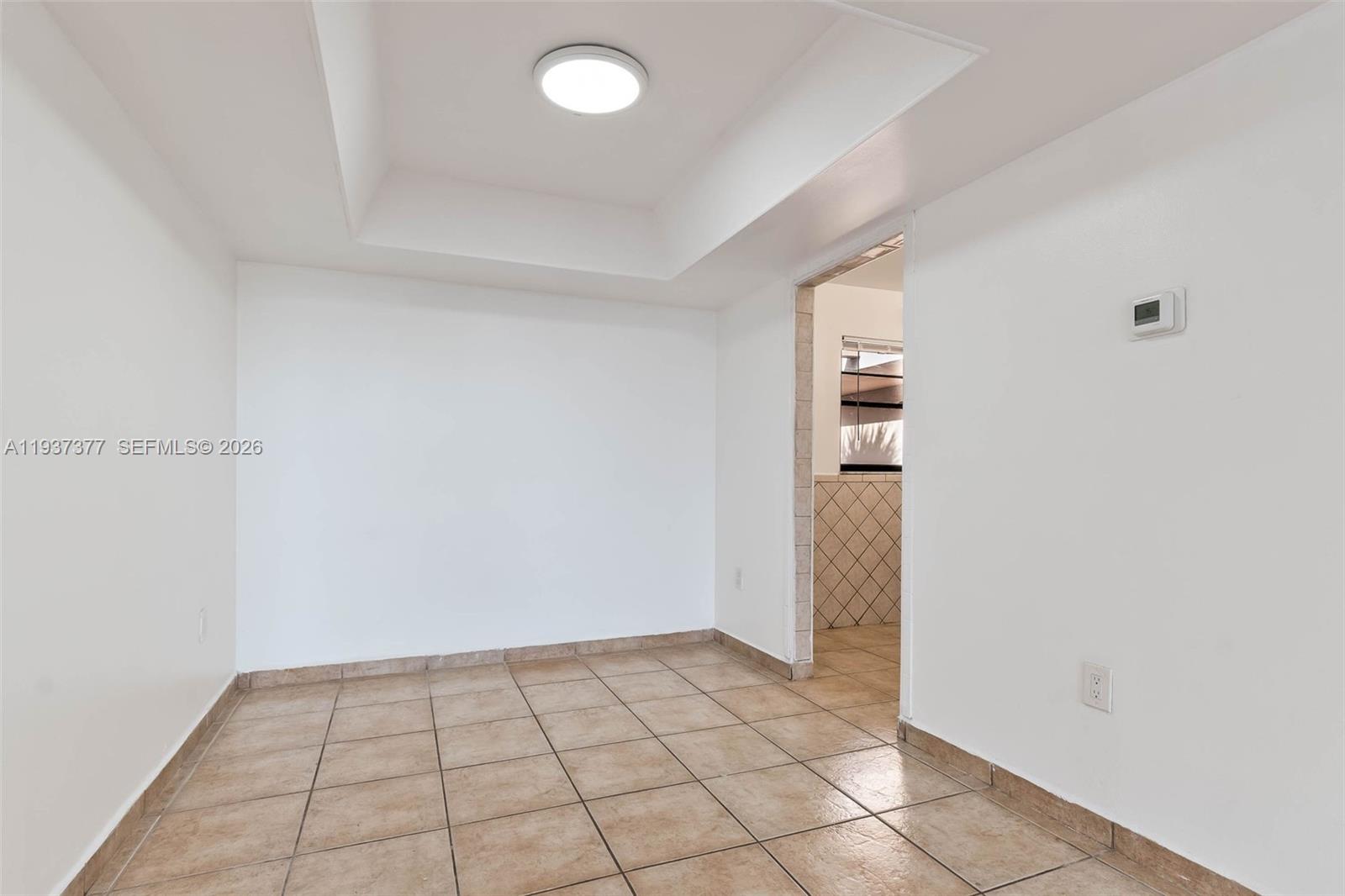 10985 Southwest 107th Street, Unit 310 Miami, FL 33176 - Photo 4 of 30 a view of an empty room and window