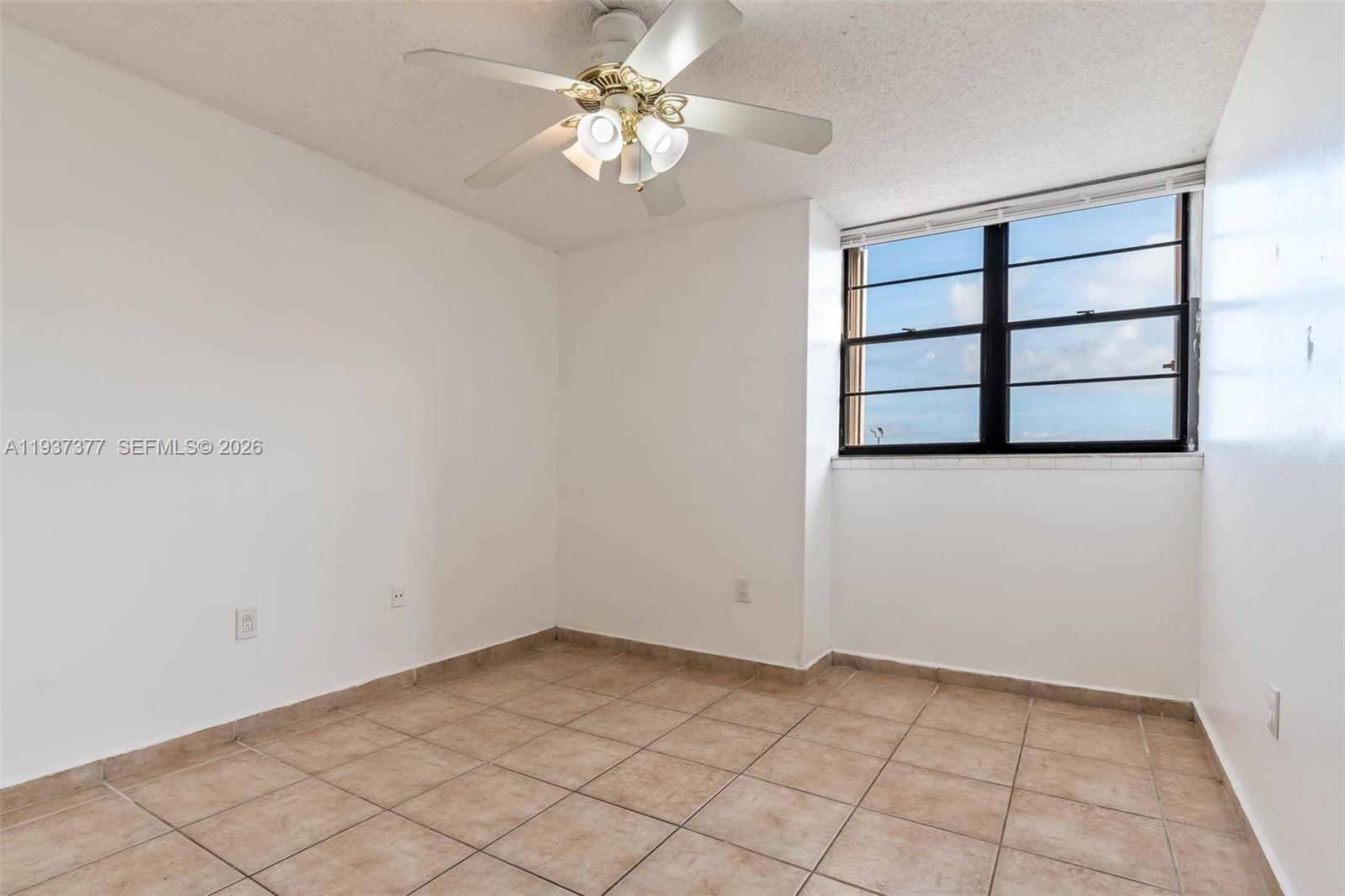 10985 Southwest 107th Street, Unit 310 Miami, FL 33176 - Photo 8 of 30 wooden floor in an empty room with a window