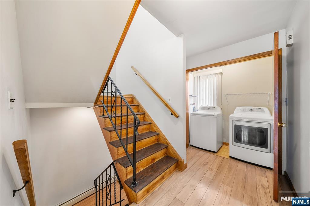 140 Allwood Road, Unit C Clifton, NJ 07012 - Photo 8 of 31 a view of a livingroom with wooden floor and staircase