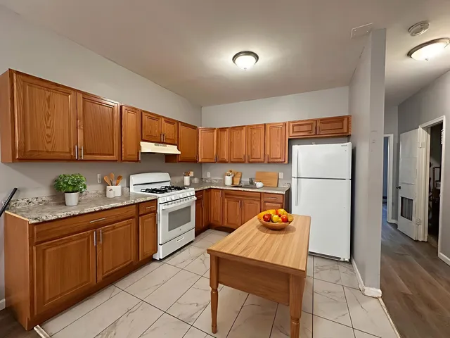 a kitchen with stainless steel appliances granite countertop a refrigerator sink and cabinets