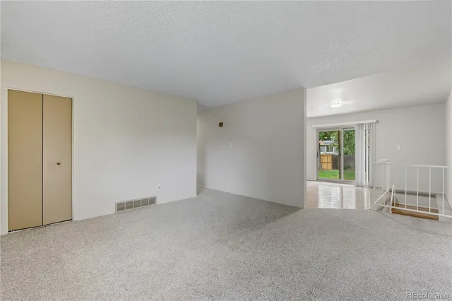 a view of kitchen with stainless steel appliances cabinets and a window