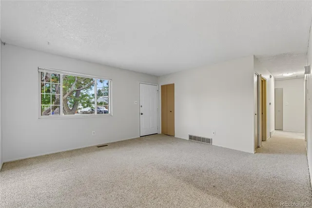 a kitchen with stainless steel appliances a stove refrigerator and microwave