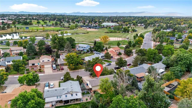 an aerial view of a city with lots of residential buildings ocean and mountain view in back