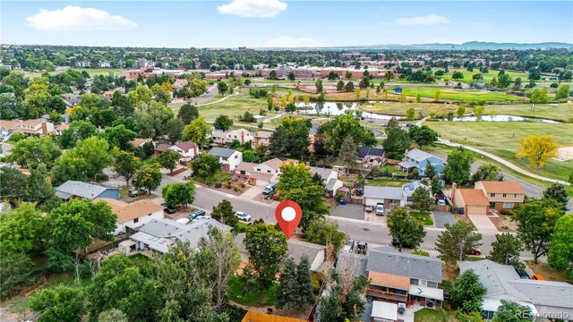 an aerial view of residential houses with outdoor space and swimming pool