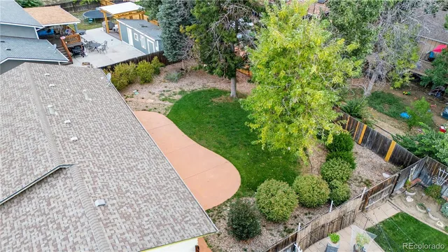 an aerial view of a house with a yard and swimming pool